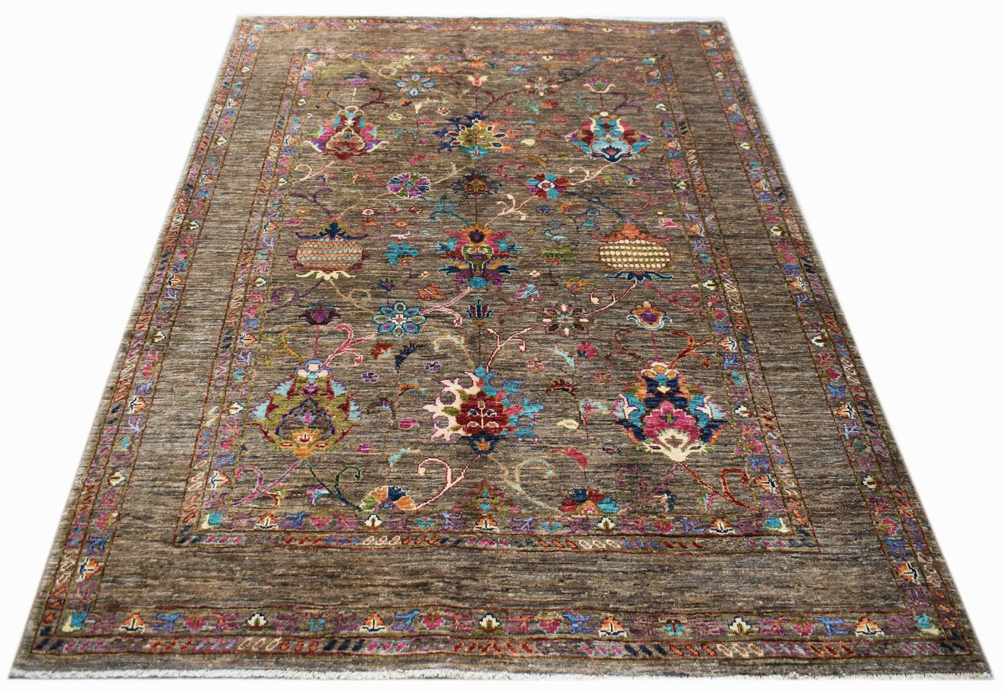 A rectangular Afghan Chobi rug featuring a brown field with colorful floral and geometric patterns.