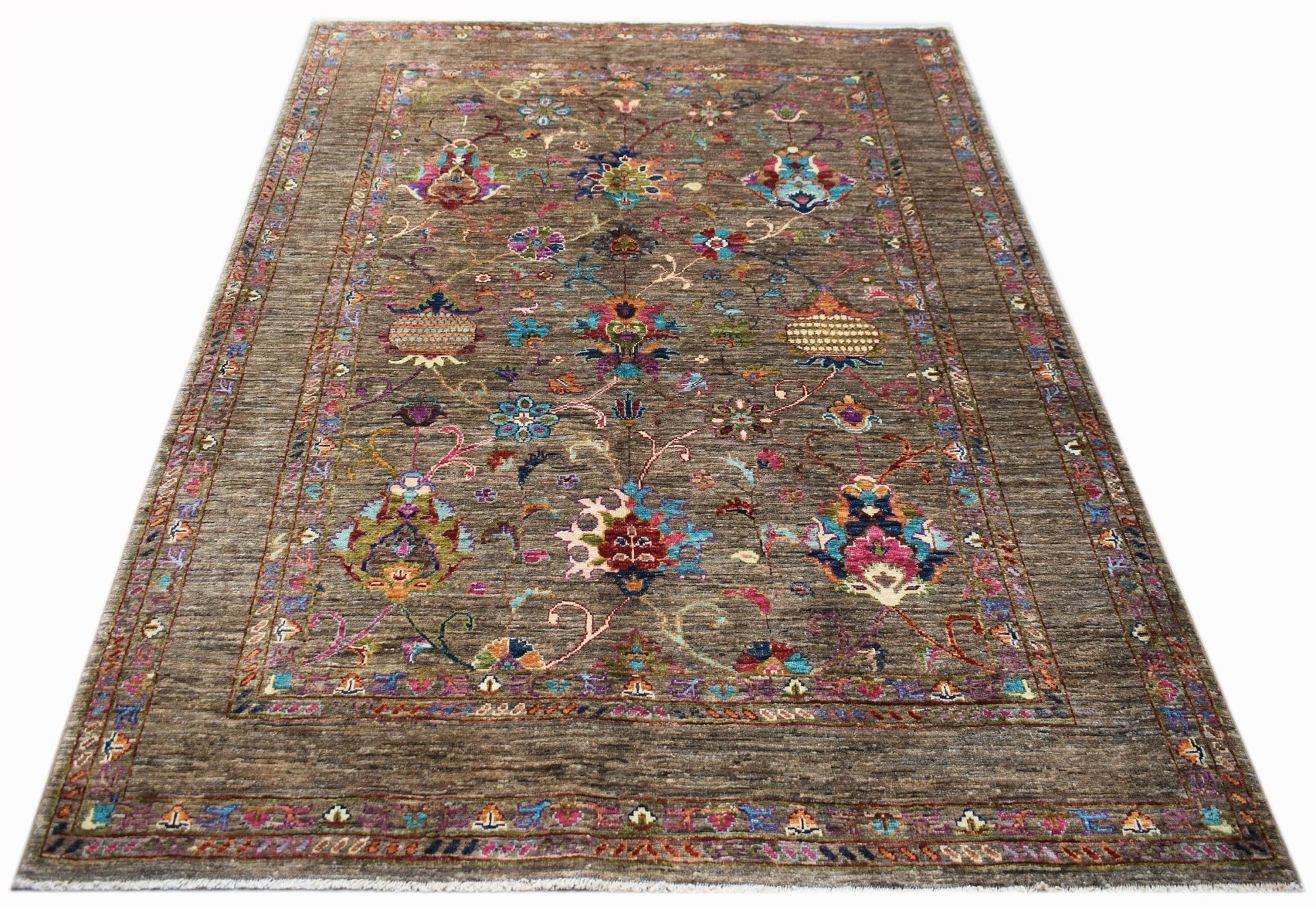 A rectangular Afghan Chobi rug featuring a brown field with colorful floral and geometric patterns.