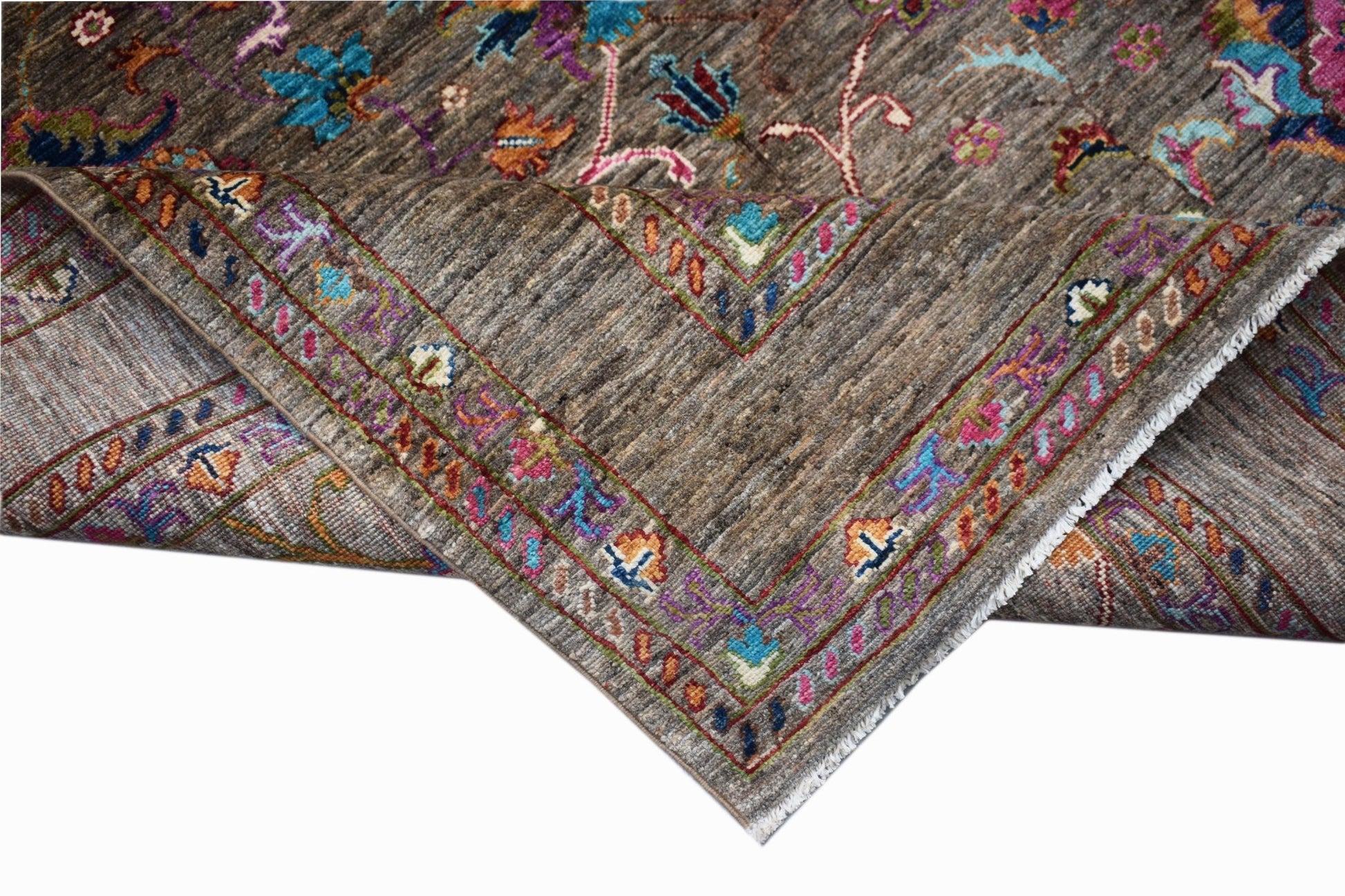 A handwoven Afghan Chobi rug featuring a brown wool base with colorful floral patterns.