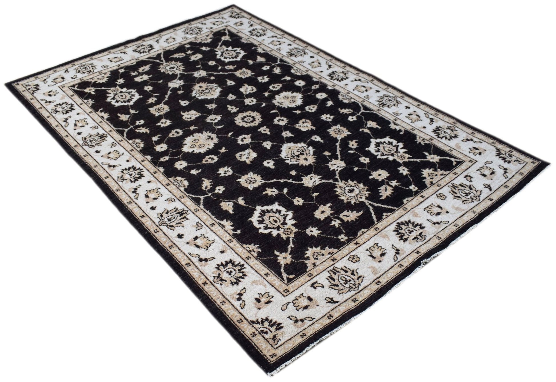 A rectangular Afghan Chobi rug featuring a dark brown field with intricate cream floral patterns.