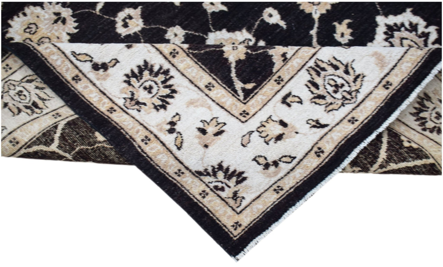 A handwoven Afghan Chobi rug featuring a traditional floral pattern in black and cream tones.