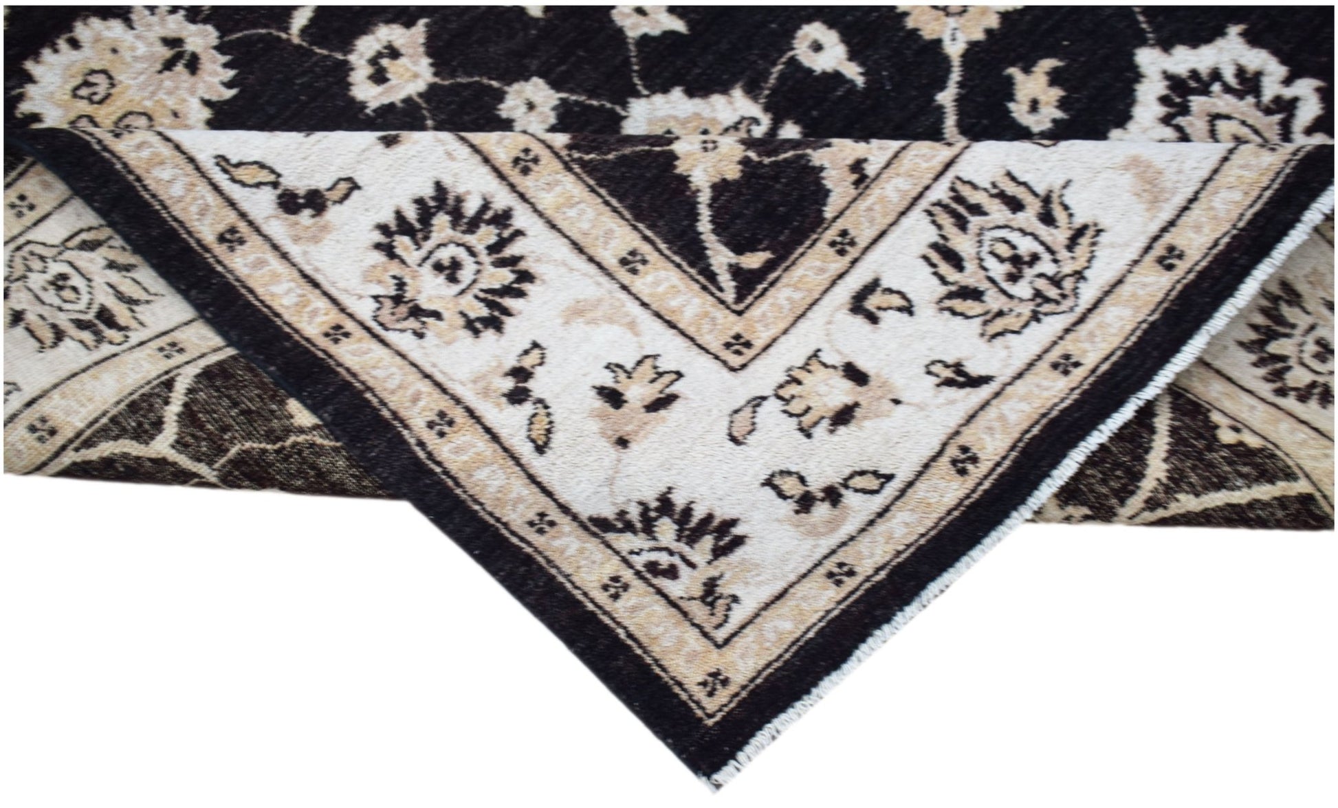 A handwoven Afghan Chobi rug featuring a traditional floral pattern in black and cream tones.