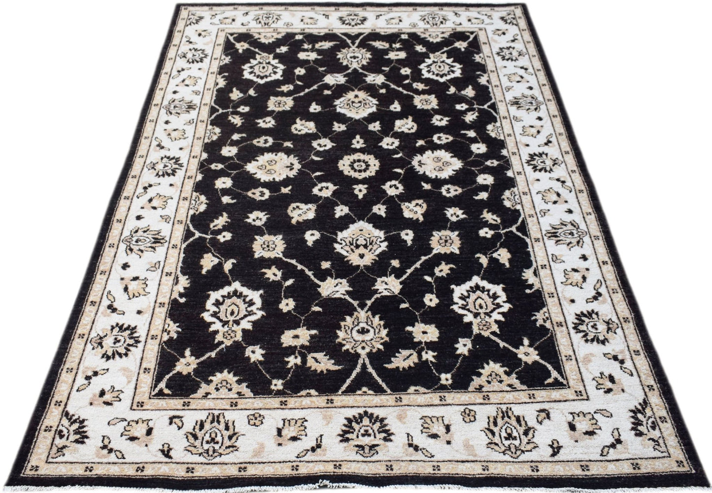 A rectangular Afghan Chobi rug featuring a black field with intricate cream floral patterns.