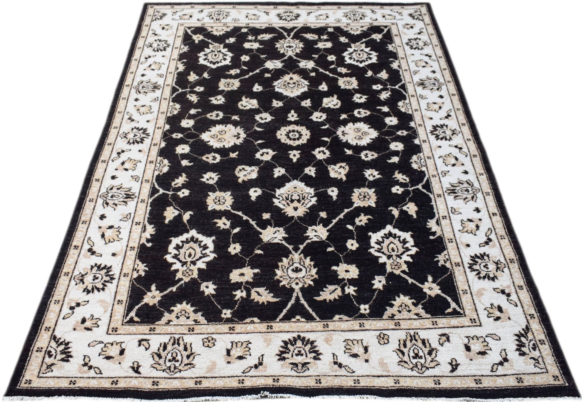 A rectangular Afghan Chobi rug featuring a black field with intricate cream floral patterns.