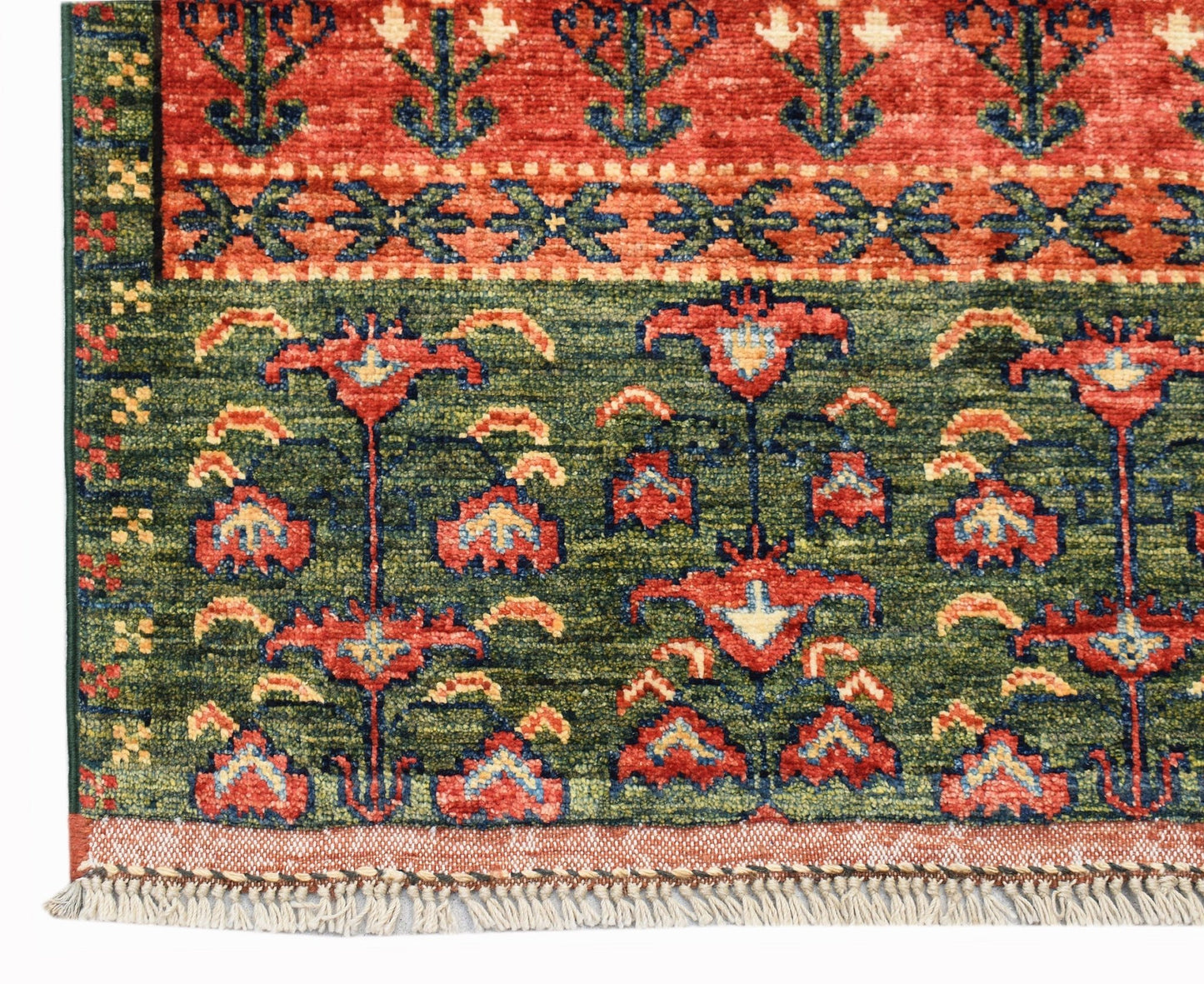 A handwoven Afghan Chobi rug featuring a floral pattern in red, green, and blue on a wool pile.