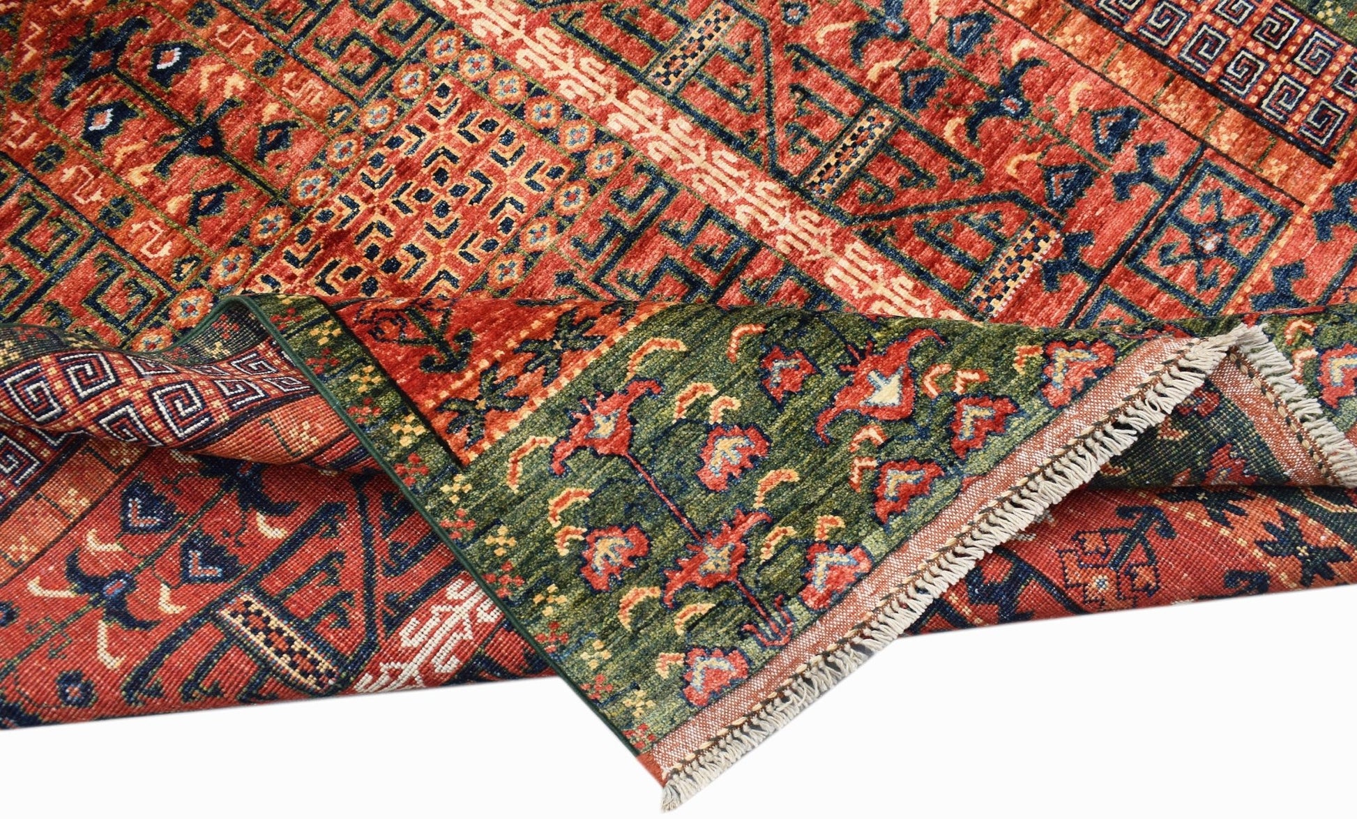A handwoven Afghan Chobi rug featuring a geometric pattern in red, blue, and green wool.
