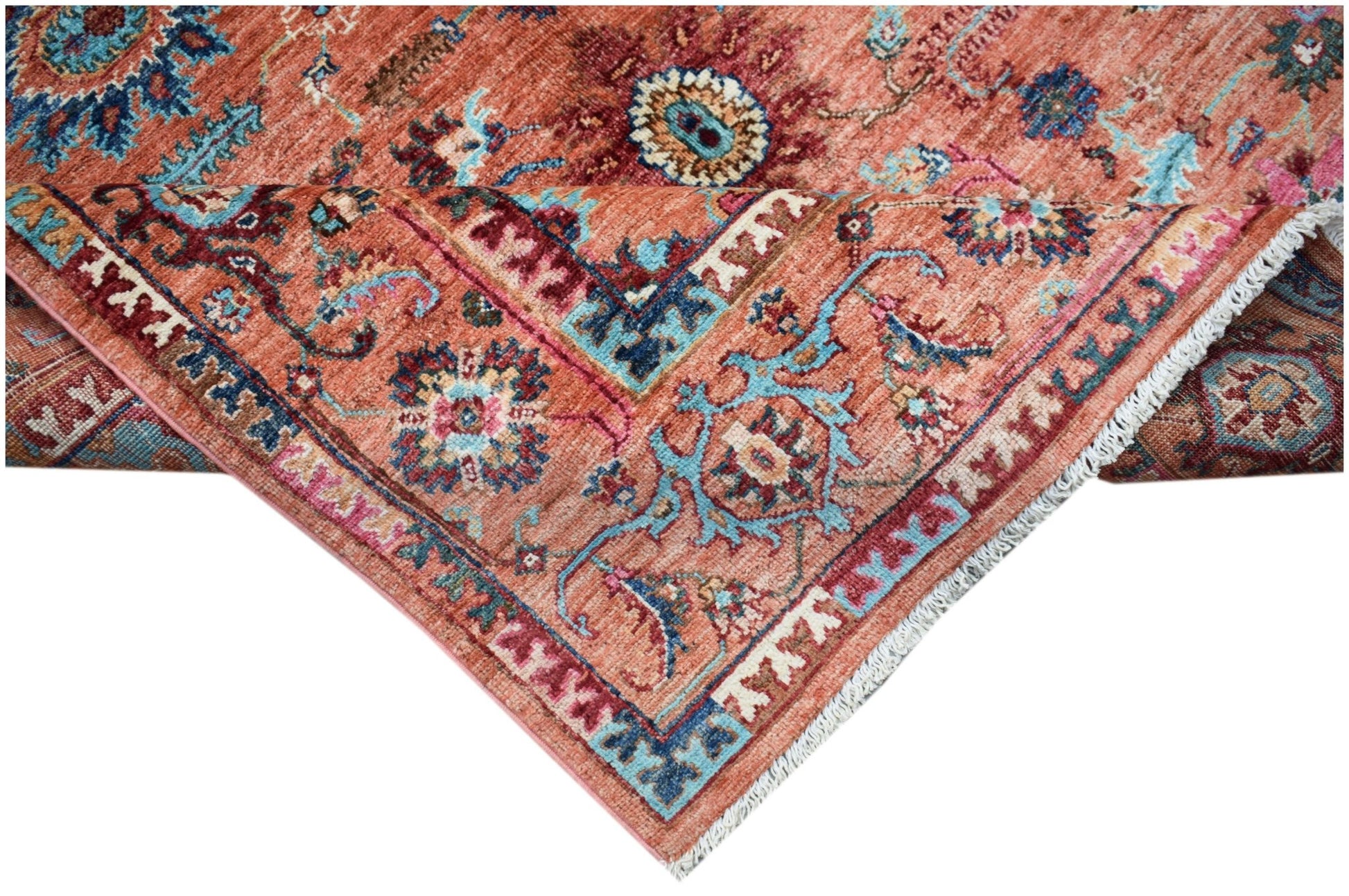 A handwoven Afghan Chobi rug featuring intricate floral patterns in shades of terracotta and blue.
