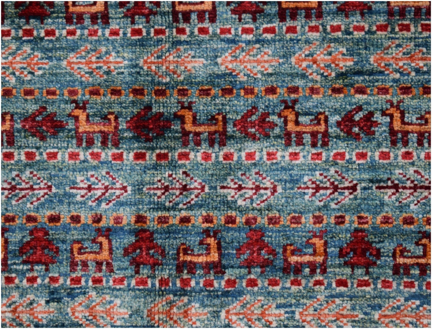 Handmade Afghan Chobi rug featuring a blue field with repeating animal and floral motifs.