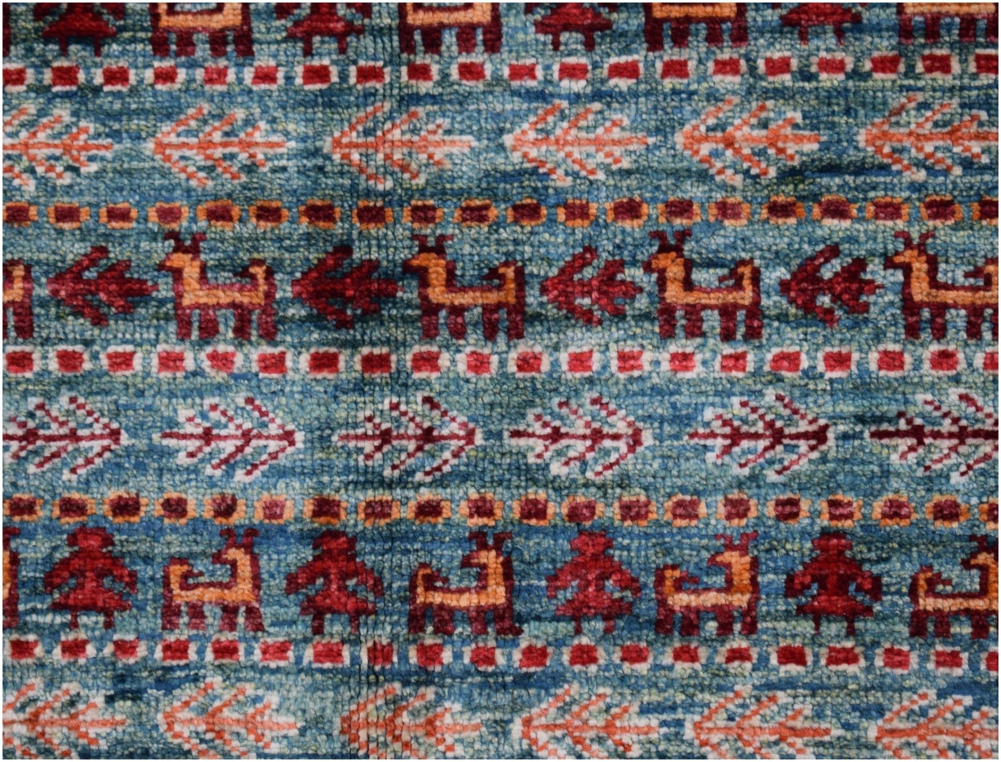 Handmade Afghan Chobi rug featuring a blue field with repeating animal and floral motifs.