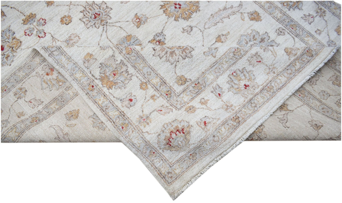 A handmade Afghan Chobi rug featuring a traditional floral pattern in soft, earthy tones.