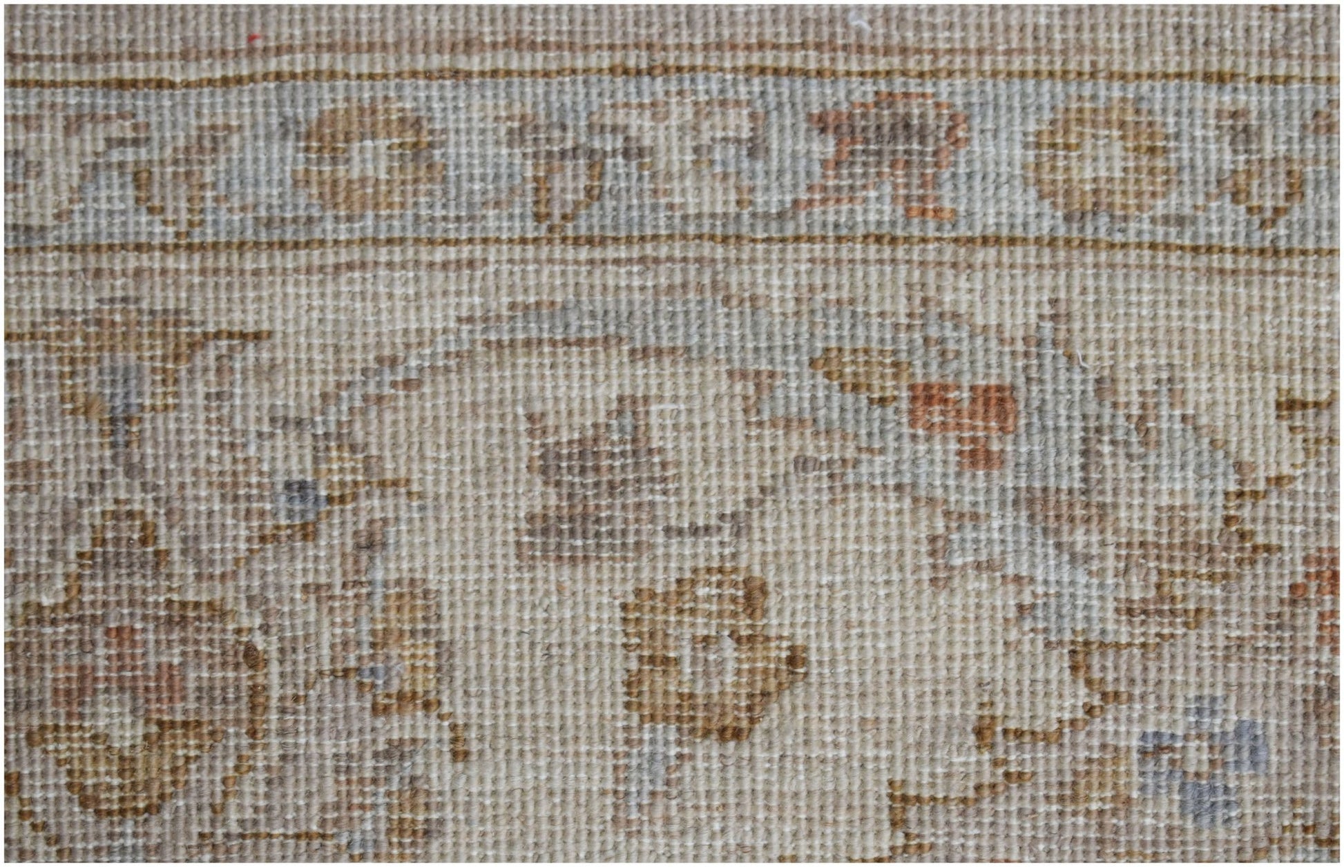 A close-up of a handwoven Afghan Chobi rug featuring traditional floral patterns in earthy tones.