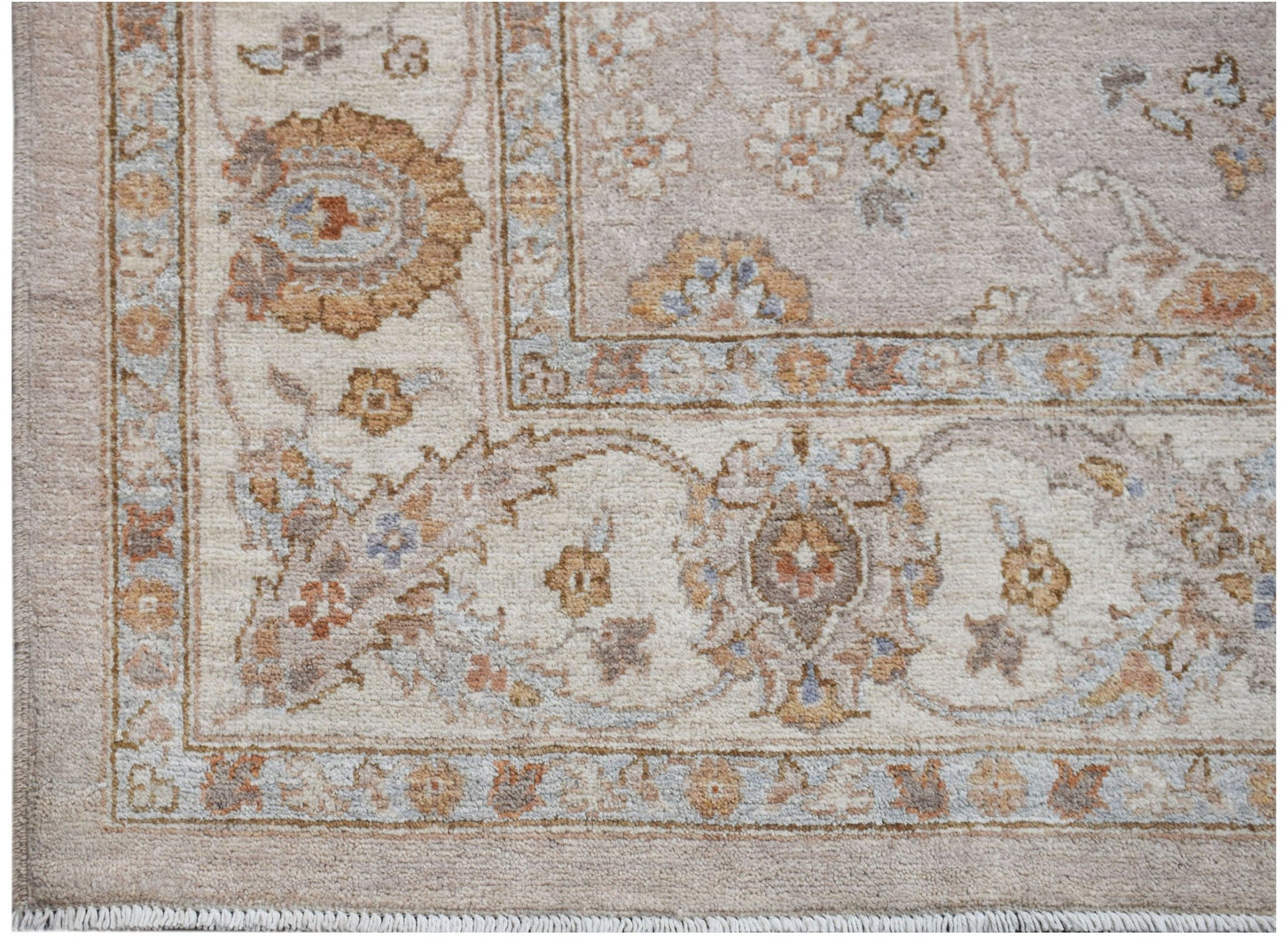 A handmade Afghan Chobi rug featuring a traditional floral pattern in soft, earthy wood tones.