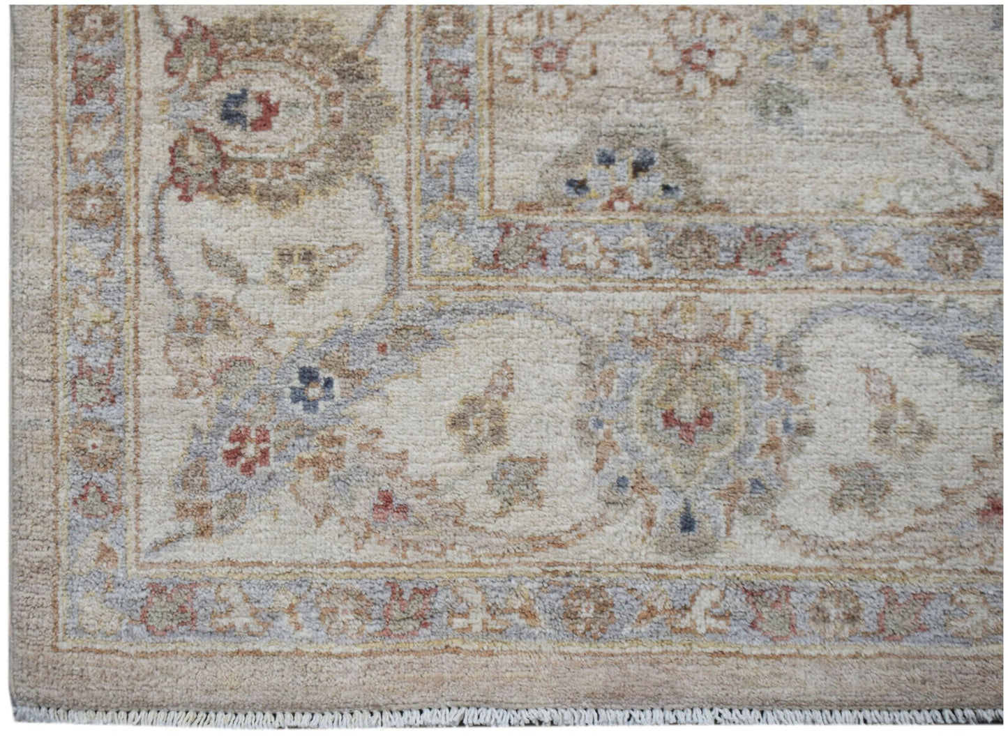 A handmade Afghan Chobi rug featuring a traditional floral pattern in soft, earthy tones.