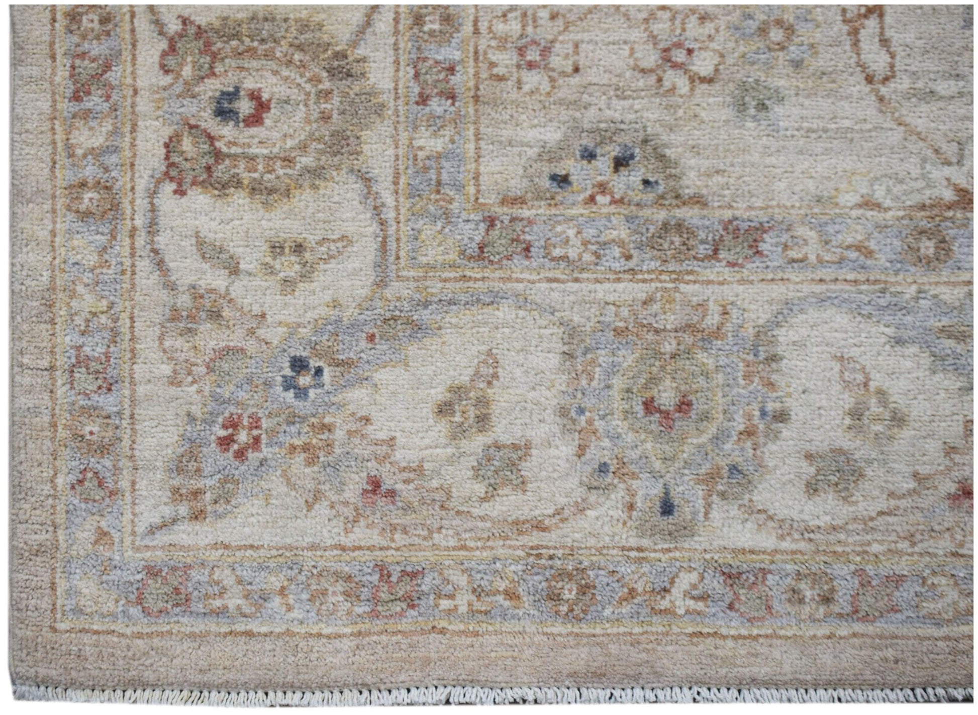 A handmade Afghan Chobi rug featuring a traditional floral pattern in soft, earthy tones.