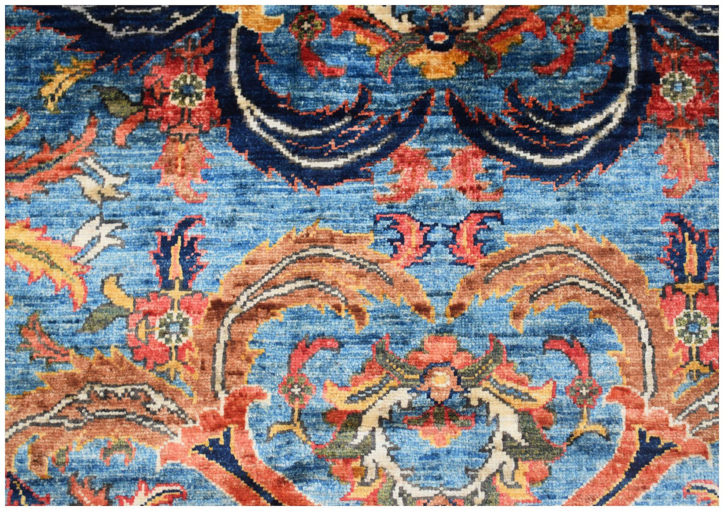 A handwoven Afghan Chobi rug featuring intricate floral patterns in blue, red, and earthy tones.