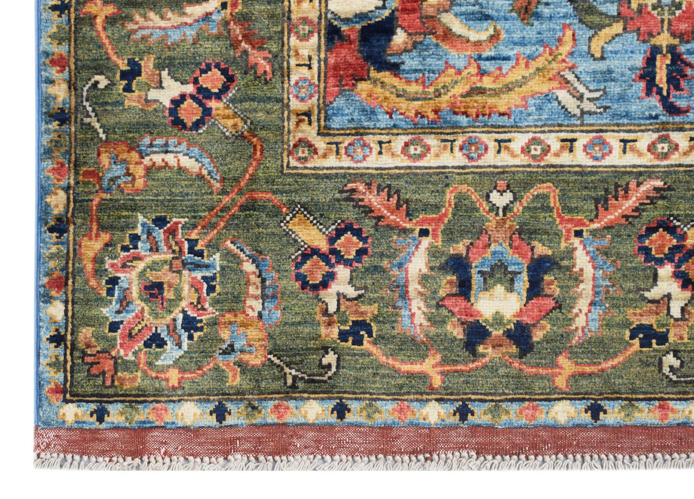 A close-up of an Afghan Chobi rug featuring intricate floral patterns in green, blue, and red.