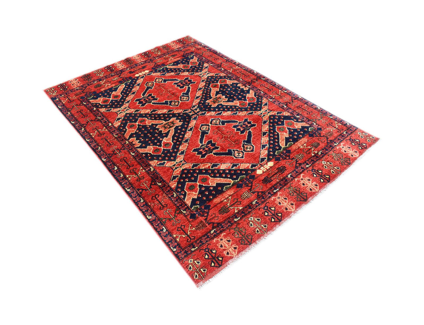 A handmade Afghan Chobi rug featuring a traditional geometric pattern in red and navy blue.