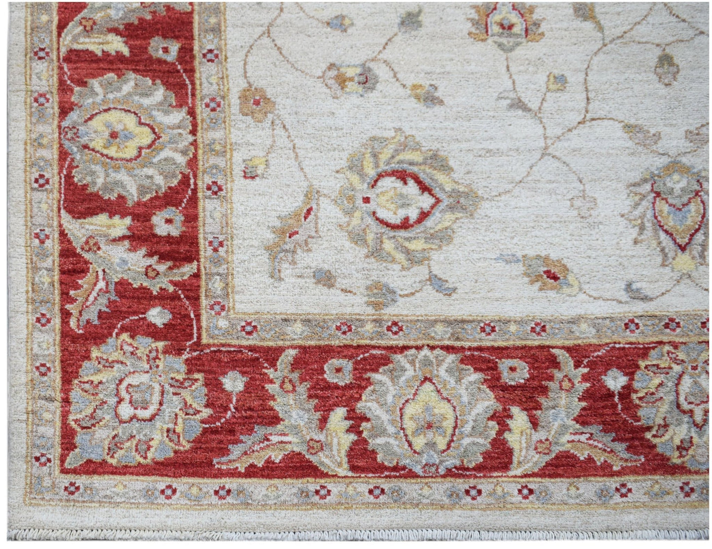 A handwoven Afghan Chobi rug featuring a traditional floral pattern in red, cream, and beige tones.