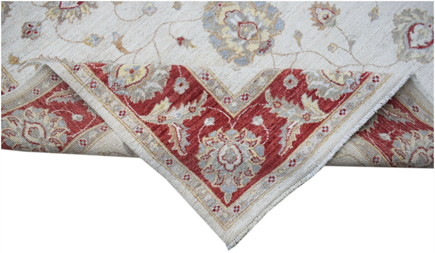A handwoven Afghan Chobi rug featuring a cream field with floral motifs and a red border.