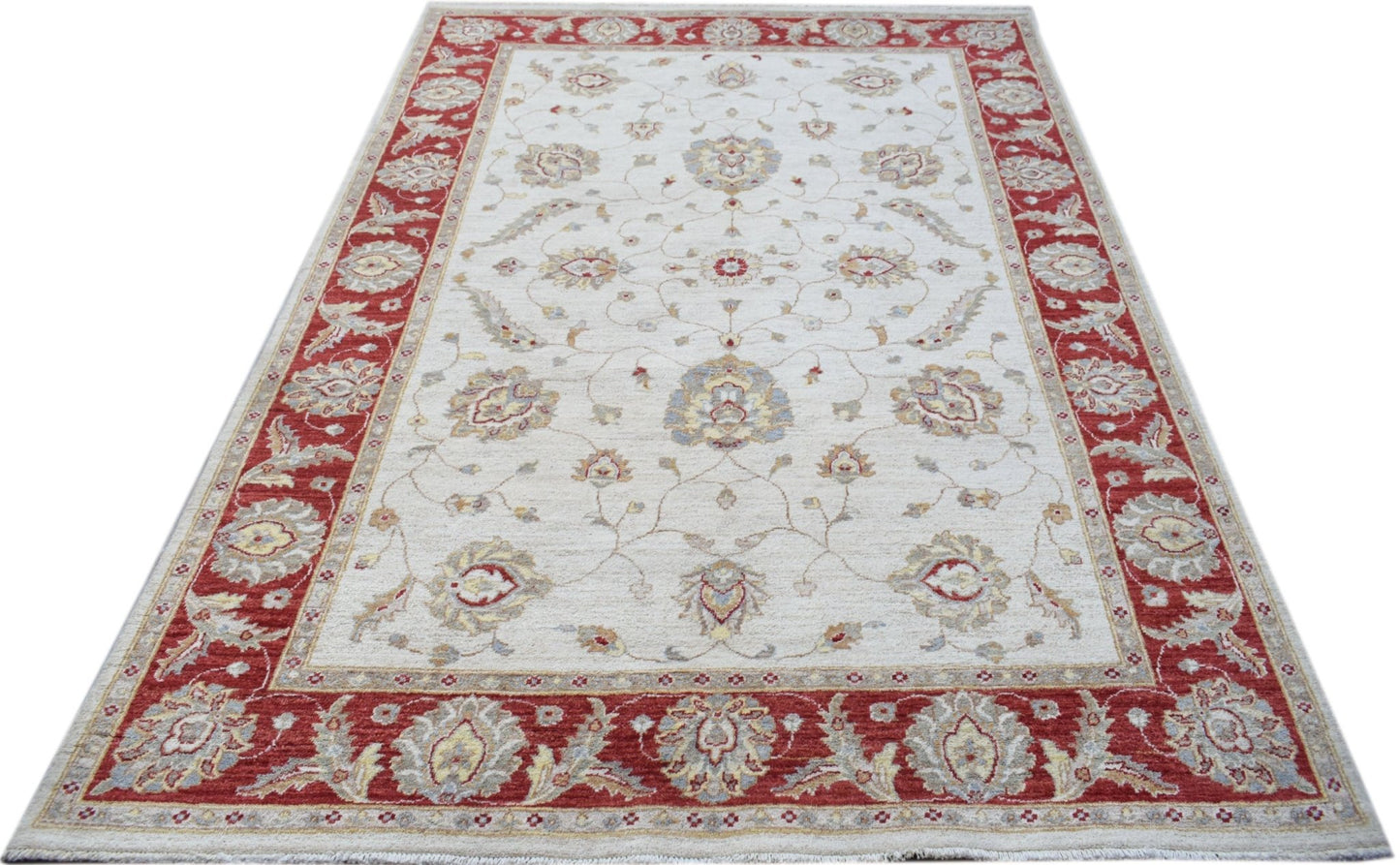 An Afghan Chobi rug featuring a floral pattern in red and beige tones on a cream background.