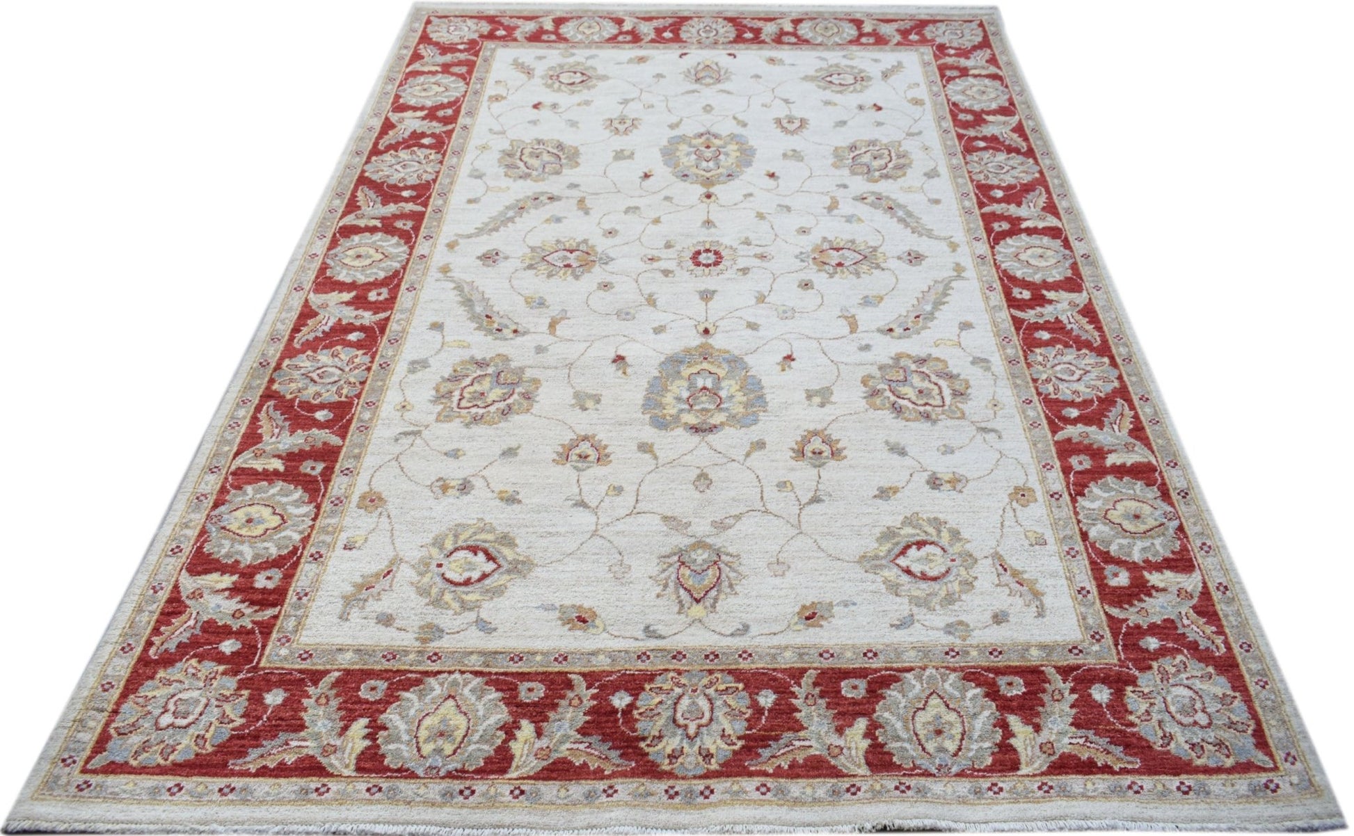 An Afghan Chobi rug featuring a floral pattern in red and beige tones on a cream background.