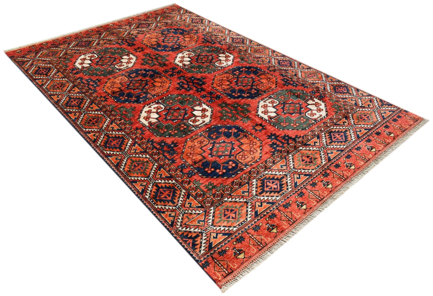 An Afghan Chobi rug featuring a traditional geometric pattern in shades of red, blue, and green.