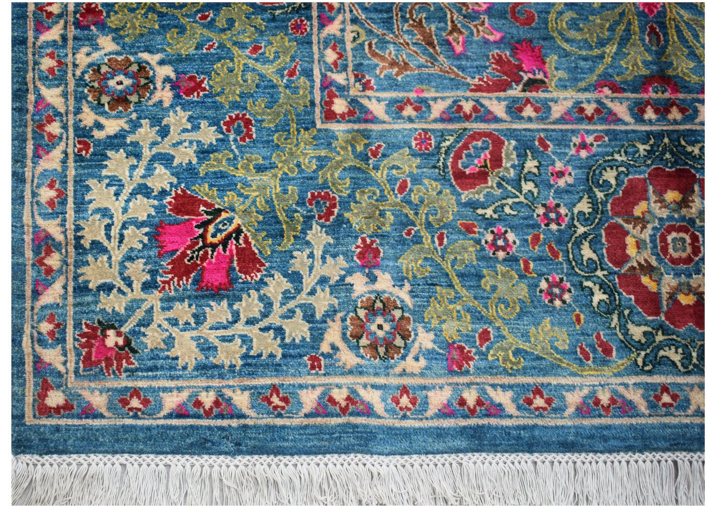 A handmade Afghan Chobi rug featuring intricate floral patterns in red, blue, and beige tones.