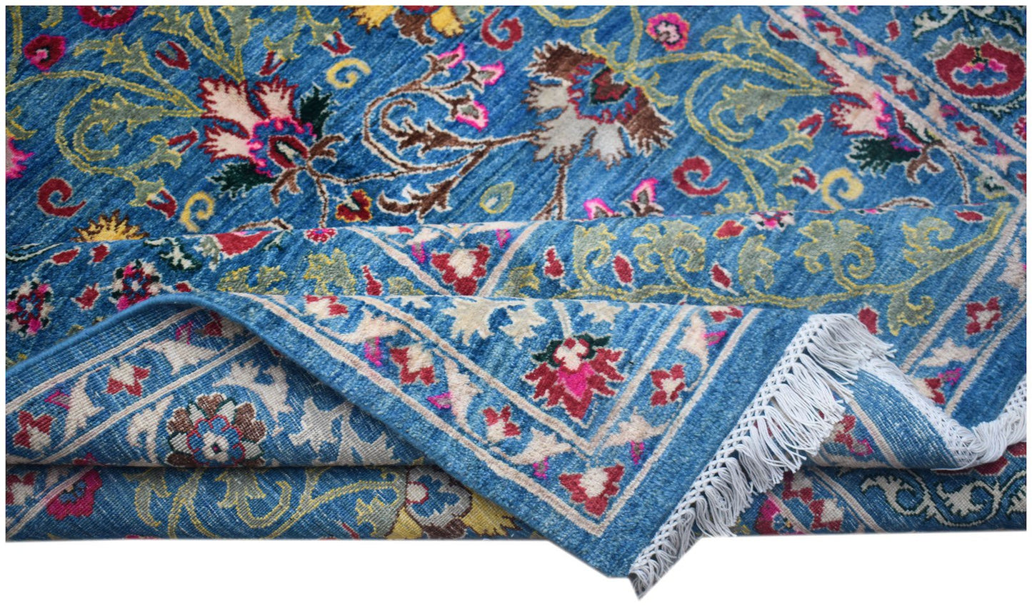 A handwoven Afghan Chobi rug featuring intricate floral patterns in blue, red, and cream tones.