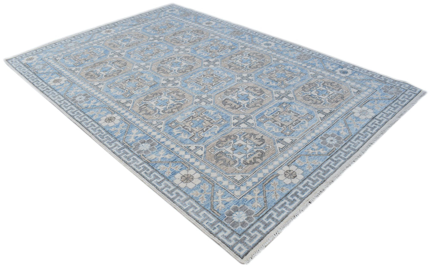 A rectangular Afghan Chobi rug featuring a blue and beige geometric pattern with a fringed edge.