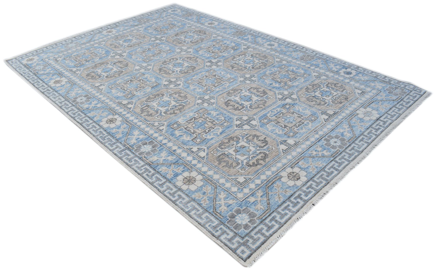 A rectangular Afghan Chobi rug featuring a blue and beige geometric pattern with a fringed edge.
