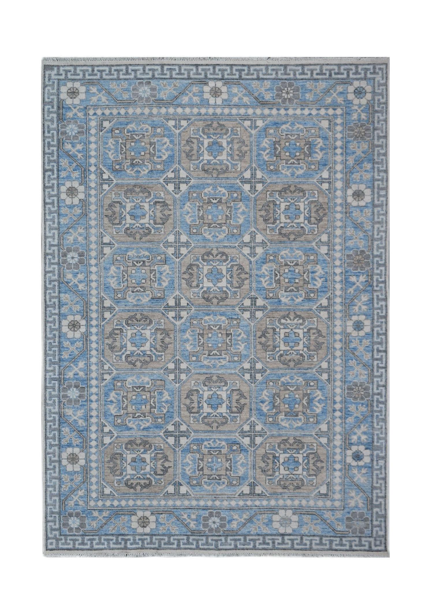 A rectangular Afghan Chobi rug featuring a geometric pattern in shades of blue, grey, and cream.