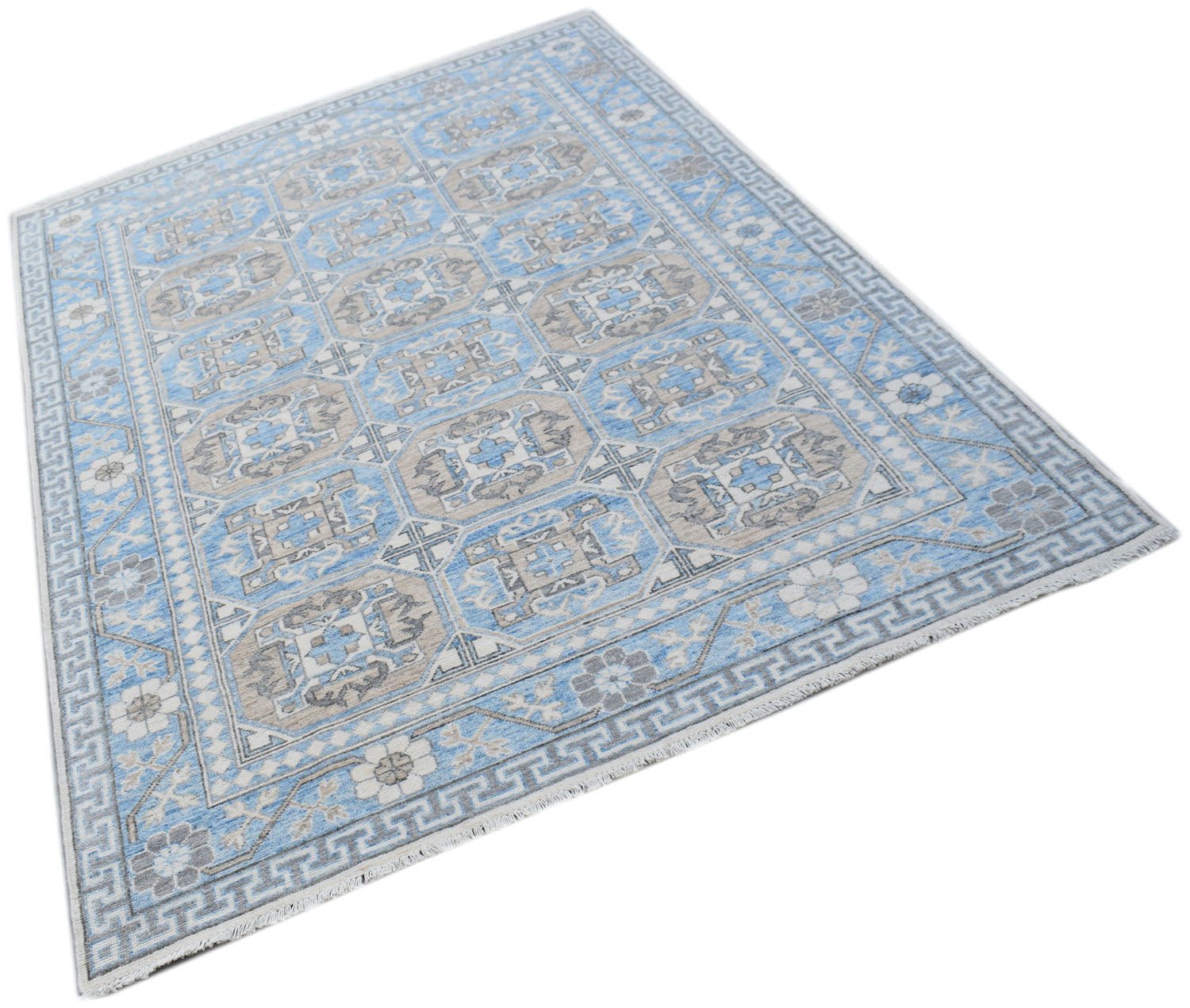 A handmade Afghan Chobi rug featuring a repeating geometric pattern in shades of blue and beige.