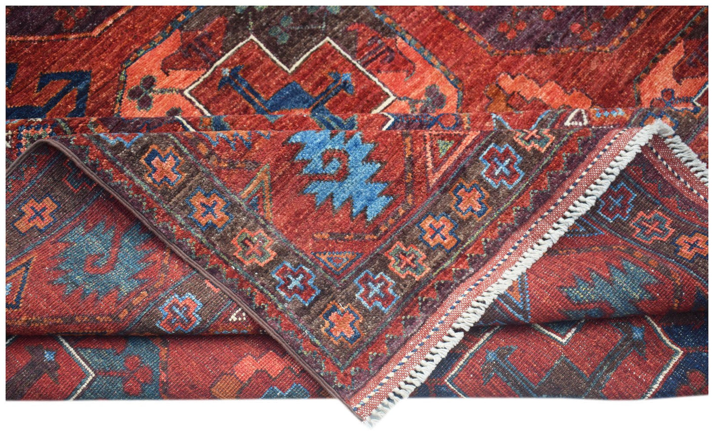 A handwoven Afghan Chobi rug featuring traditional geometric patterns in red, blue, and brown.