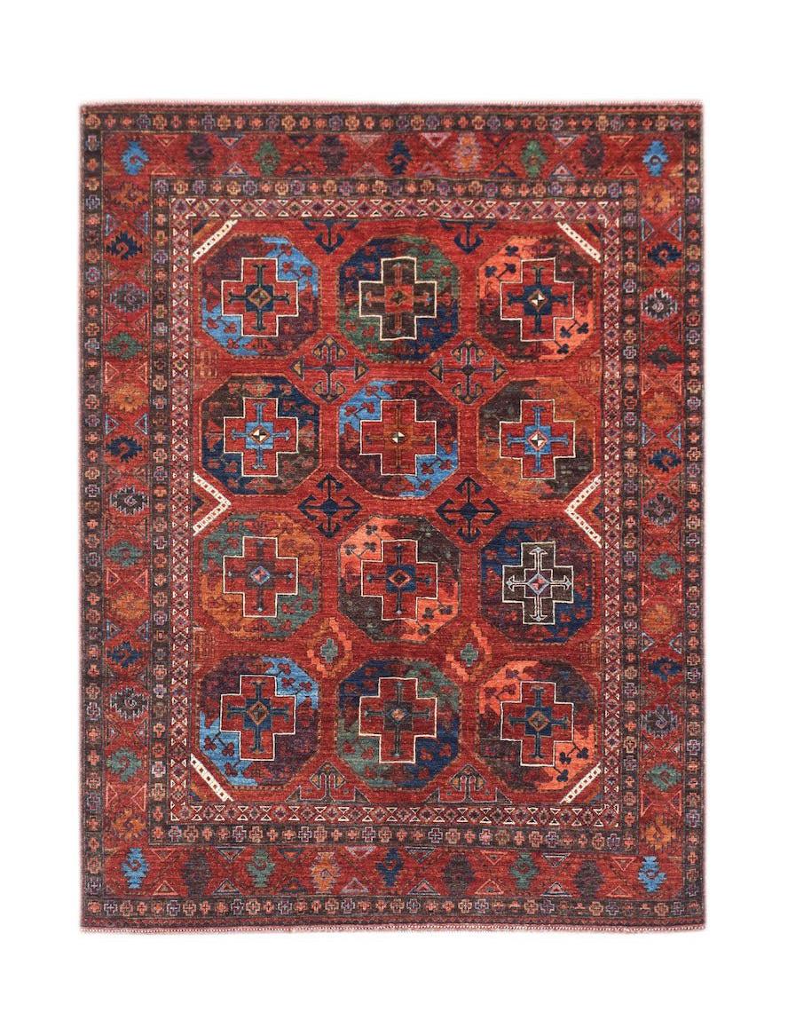 Handwoven Afghan Chobi rug featuring a geometric pattern in shades of red, blue, and brown.