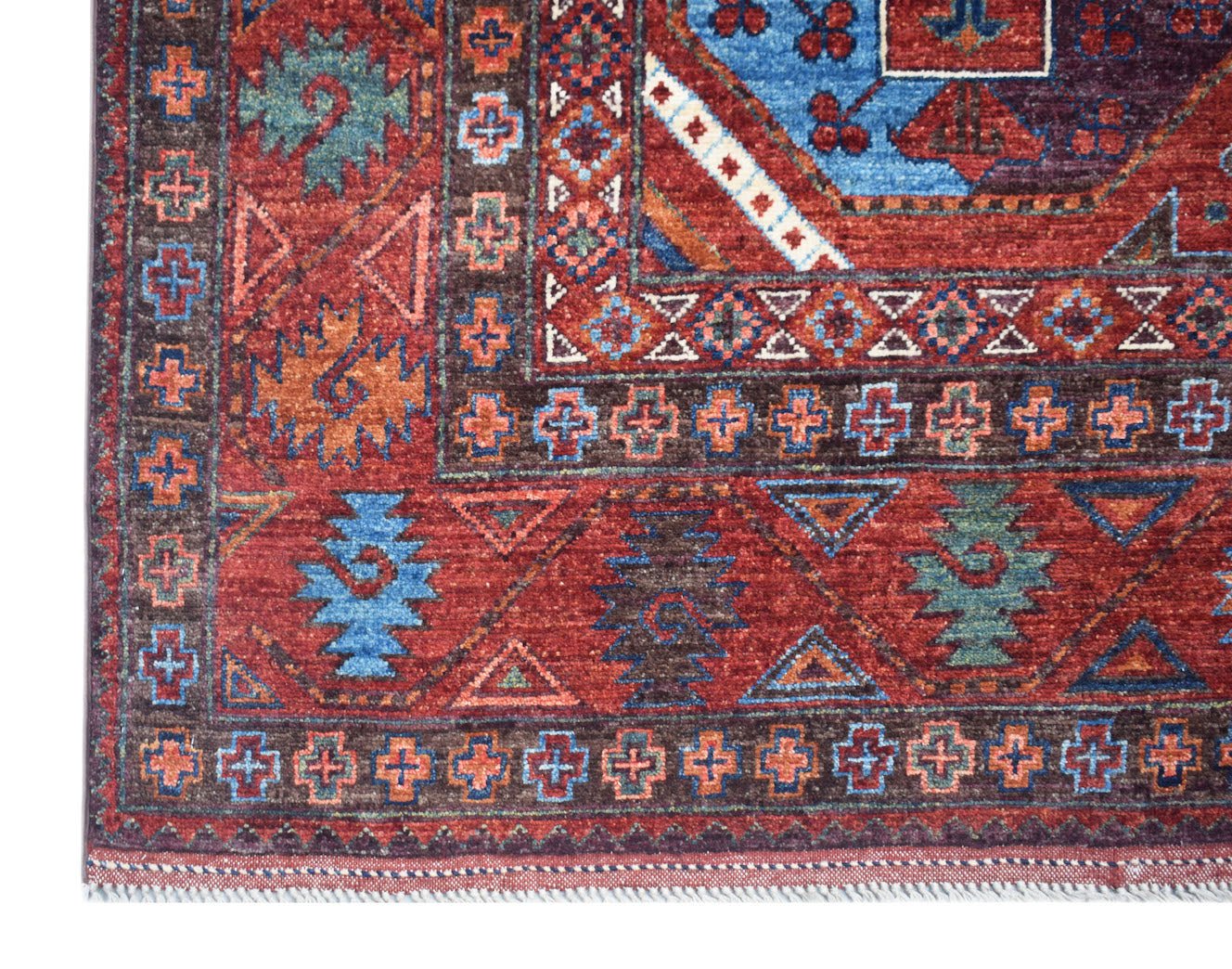 A handmade Afghan Chobi rug featuring traditional geometric patterns in red, blue, and brown tones.