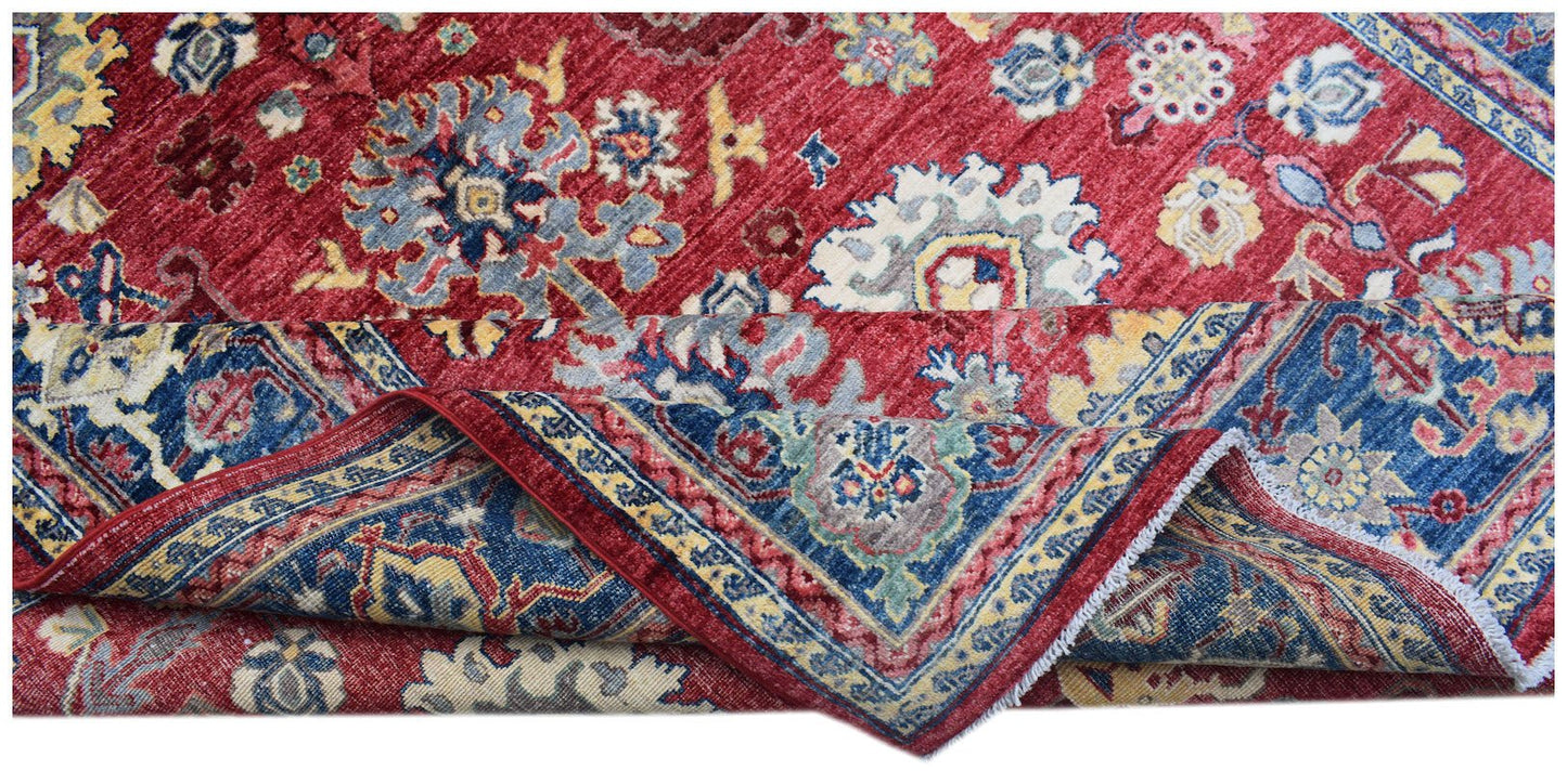 A handmade Afghan Chobi rug featuring a traditional floral pattern in red, blue, and cream tones.