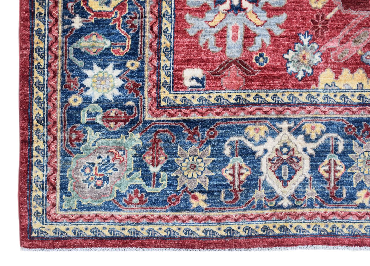 A handmade Afghan Chobi rug featuring a traditional floral pattern in red, blue, and cream tones.
