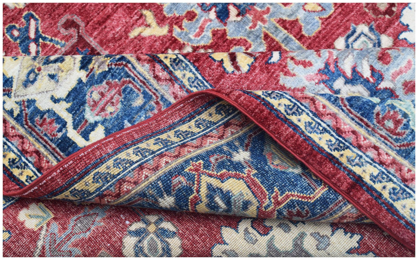 A handmade Afghan Chobi rug featuring a traditional floral pattern in red, blue, and cream tones.