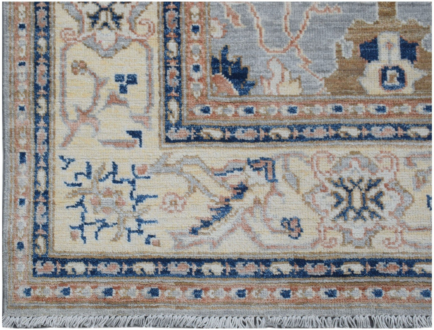 A handmade Afghan Chobi rug featuring a traditional floral pattern in blue, beige, and tan tones.