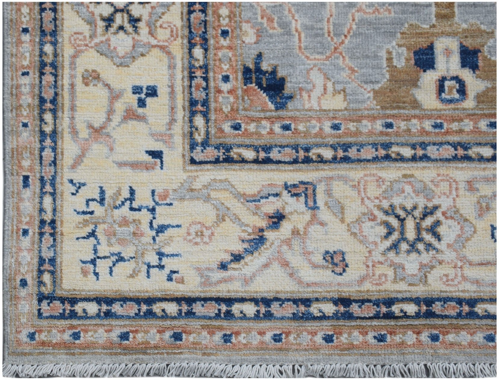 A handmade Afghan Chobi rug featuring a traditional floral pattern in blue, beige, and tan tones.