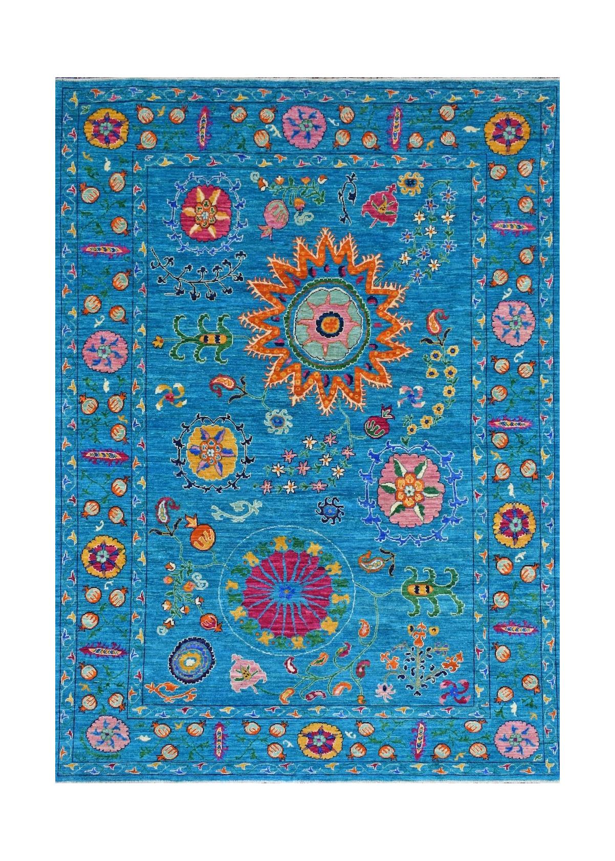 A handmade Afghan Chobi rug featuring vibrant floral and geometric motifs on a bright blue field.