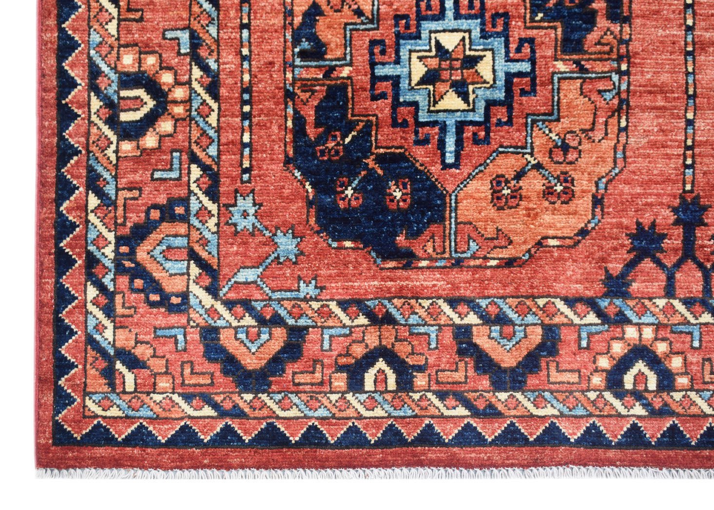 A handmade Afghan Chobi rug featuring a traditional geometric pattern in red, blue, and cream.