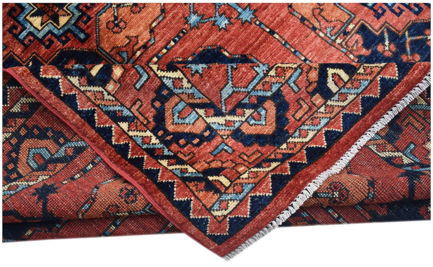A handmade Afghan Chobi rug featuring traditional geometric patterns in red, blue, and cream.
