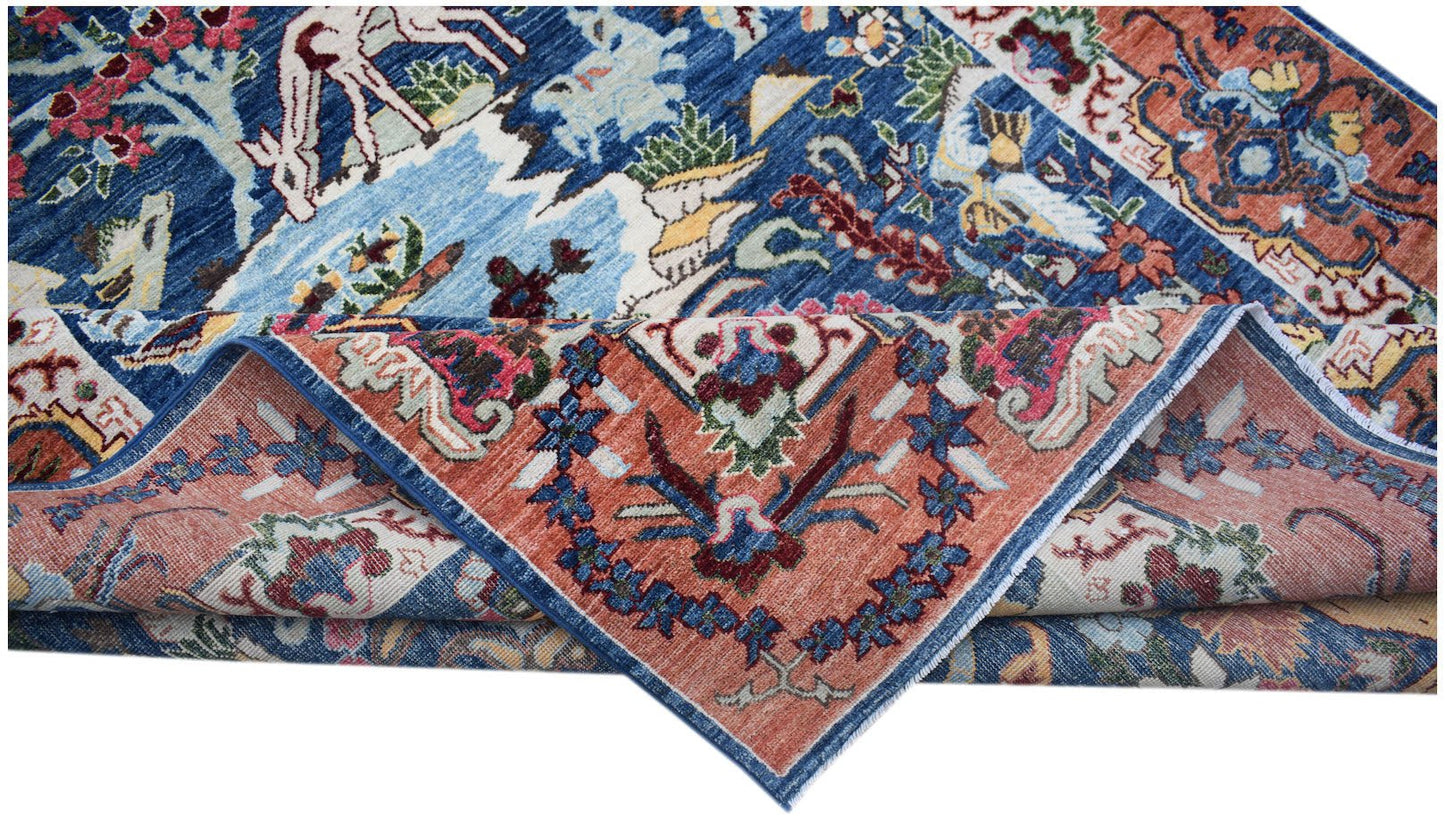 A handwoven Afghan Chobi rug featuring intricate floral and animal patterns in blue and terracotta.