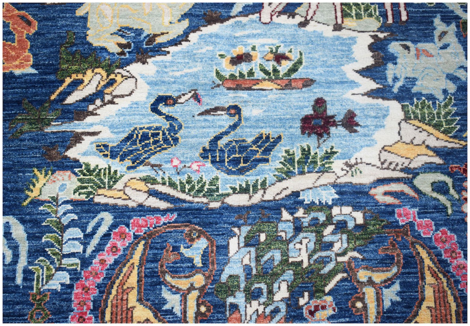 Handwoven Afghan Chobi rug featuring a blue field with intricate bird and floral motifs.