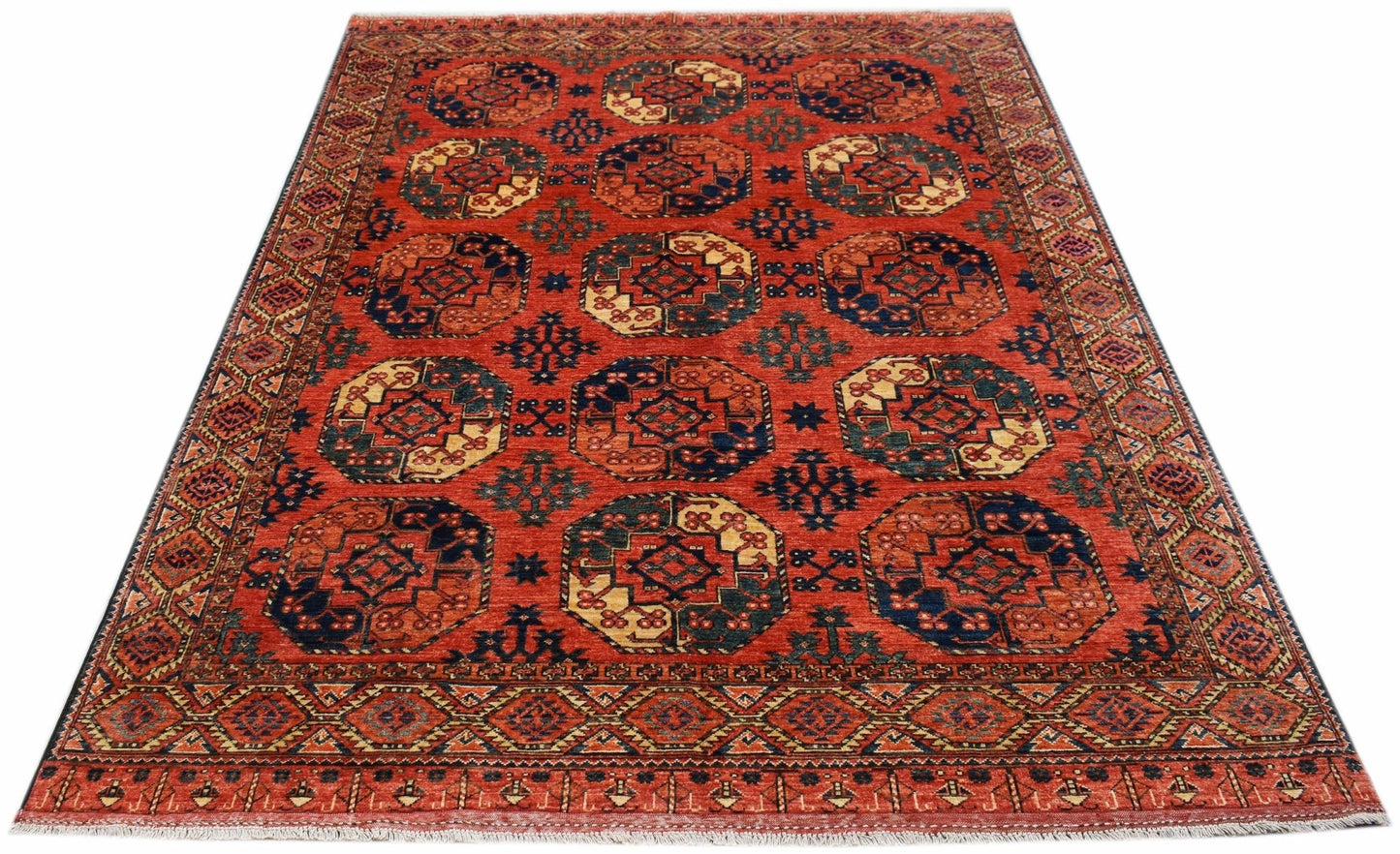 Handwoven Afghan Chobi rug featuring a repeating octagonal pattern in red, blue, and cream tones.