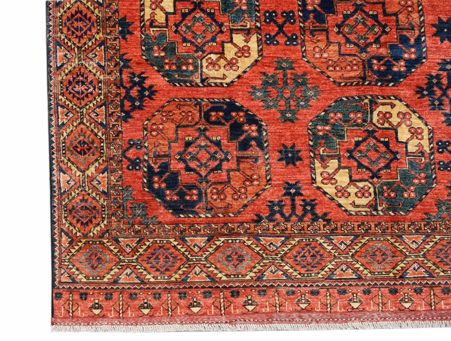 A handmade Afghan Chobi rug featuring traditional geometric patterns in red, blue, and cream tones.
