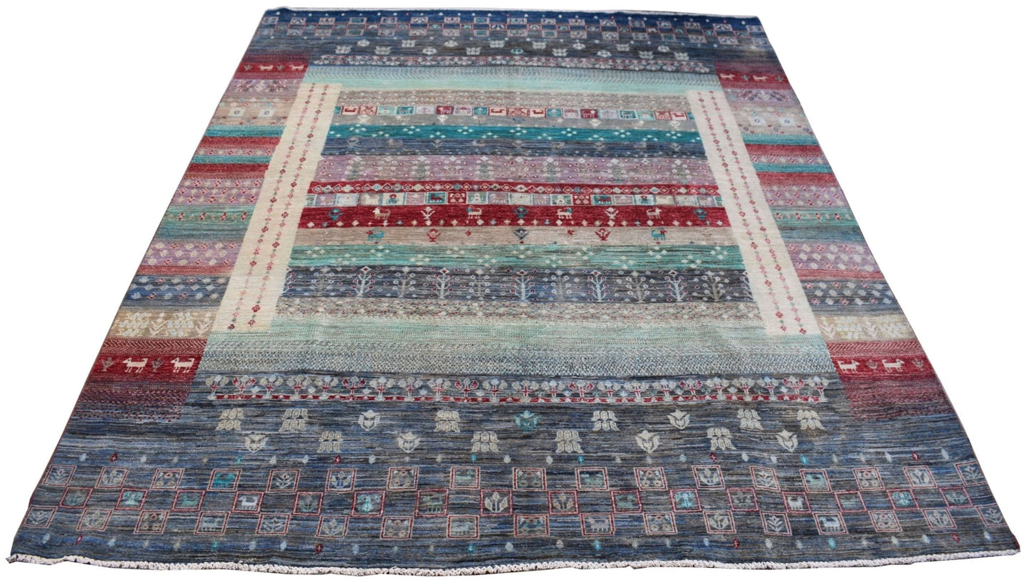 A handmade Afghan Chobi rug featuring horizontal bands of geometric patterns in earthy tones.