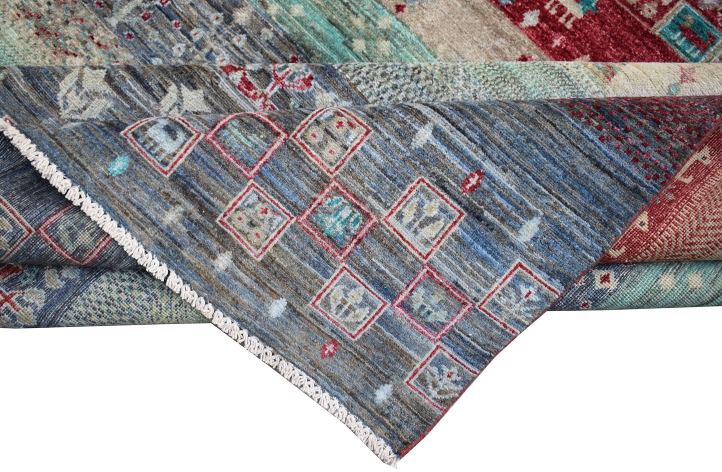 A handmade Afghan Chobi rug featuring a blue field with geometric red-bordered square motifs.