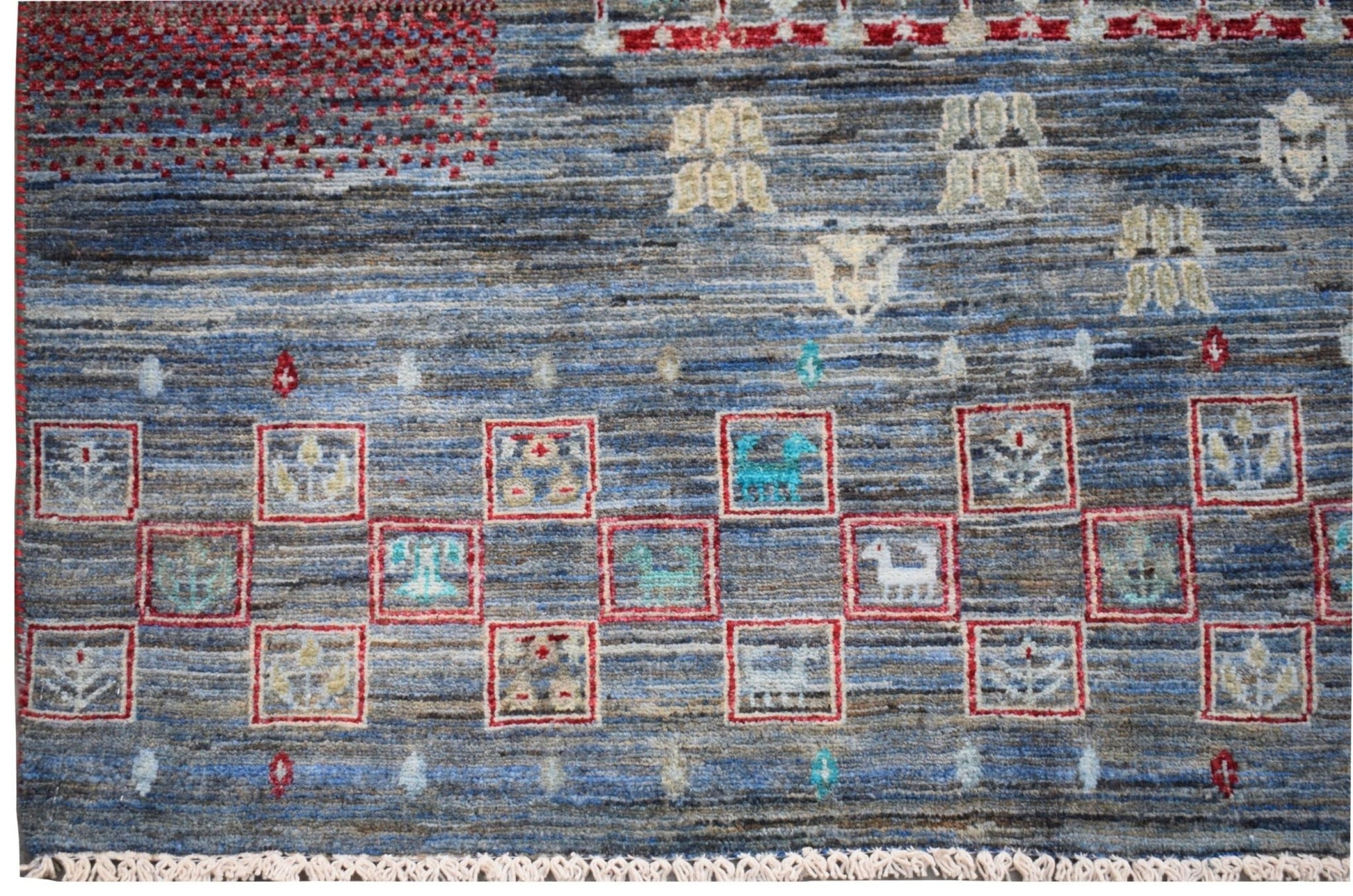 Handmade Afghan Chobi rug featuring a blue field with geometric motifs and a square-patterned border.